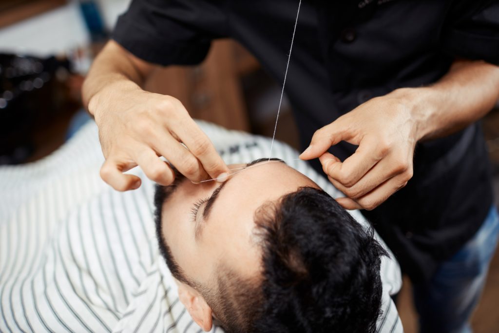 Épilation au fil chez le barbier